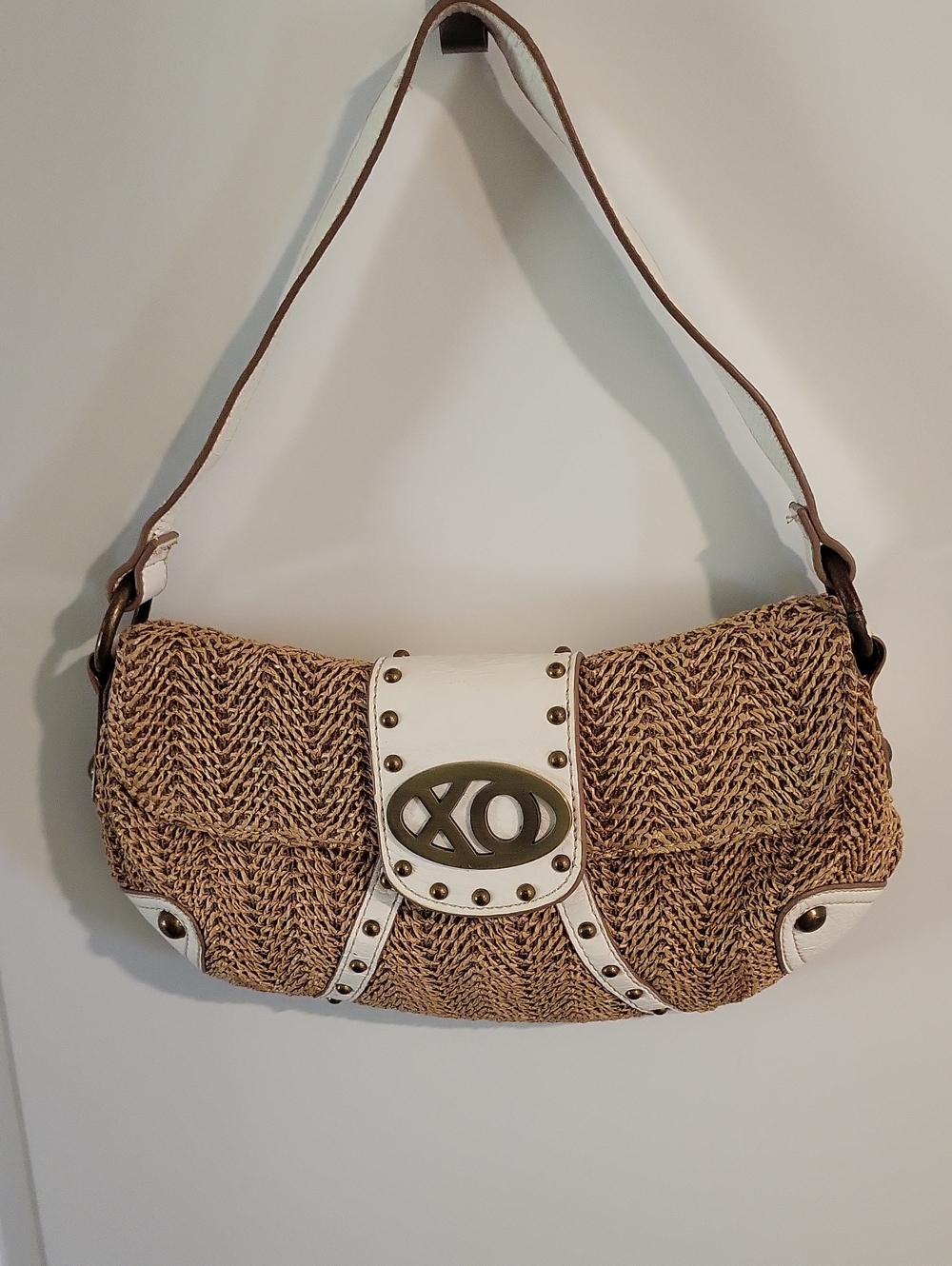 XOXO Tan Woven Clutch with White Trim and Brass Emblem.